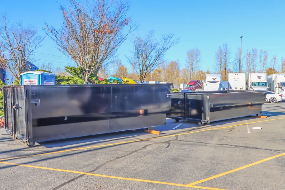 Professional dumpster rental service with roll-off container on residential driveway in Carmel